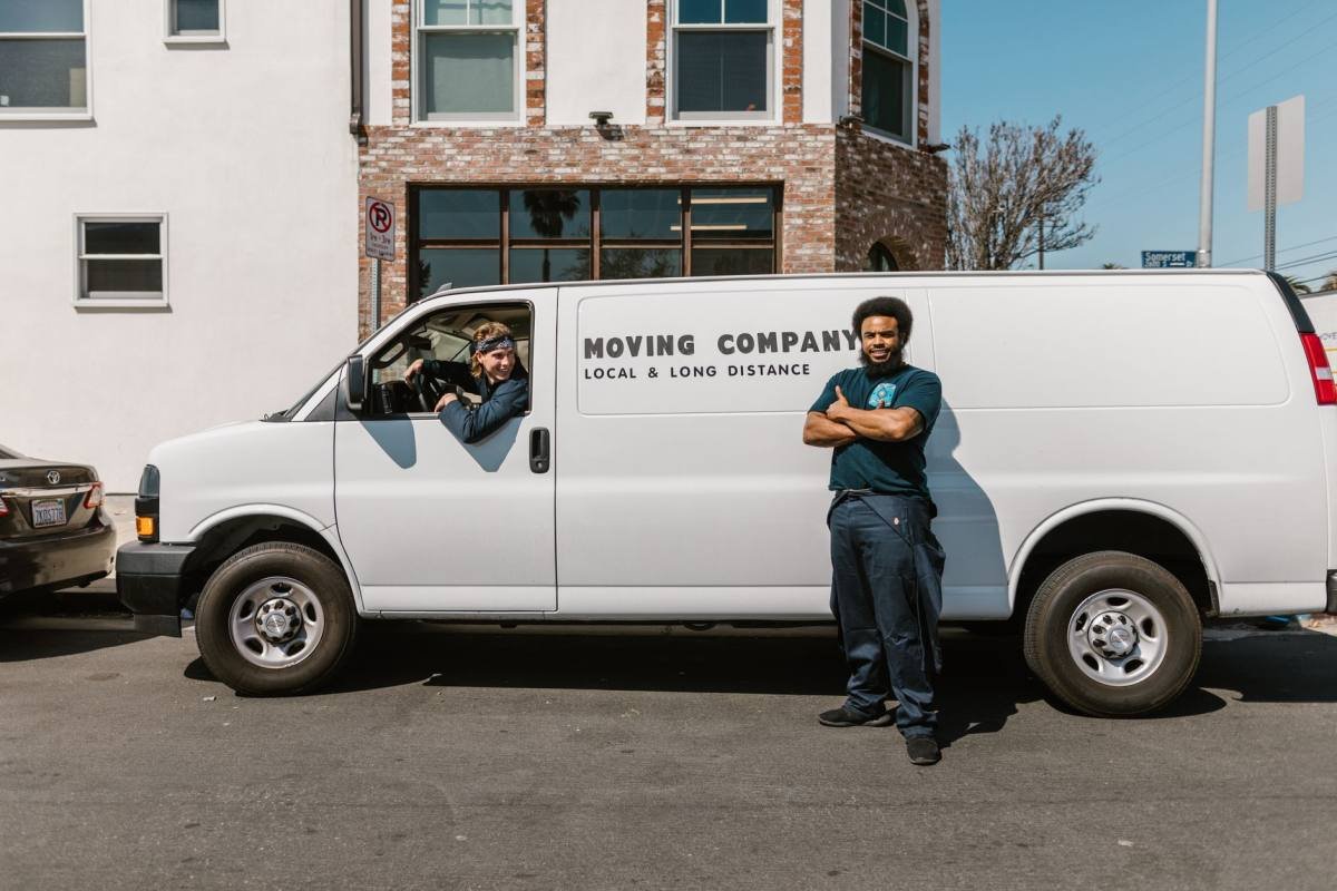 A delivery team standing beside their van