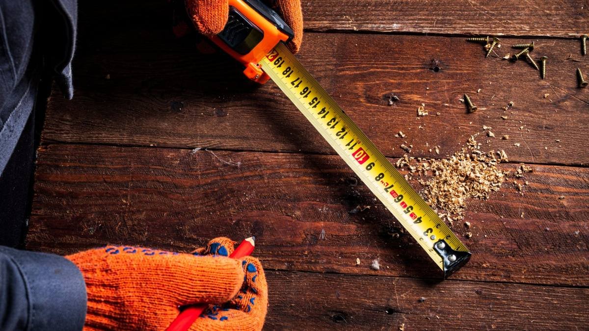 Measuring a piece of furniture with a tape measure