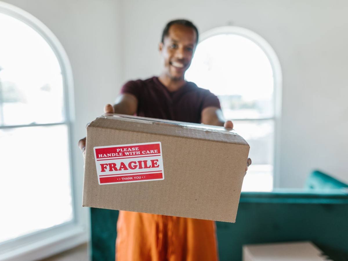 A mover carrying a cardboard box